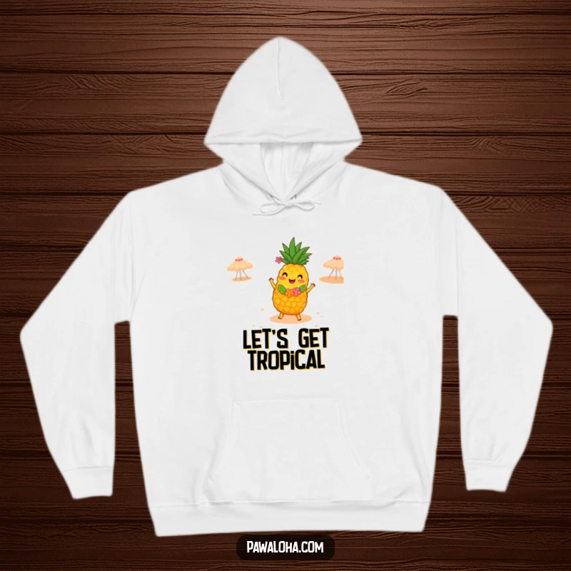 Funny hoodie featuring a joyful pineapple in a lei, dancing the hula energetically on a sandy beach, offering cozy tropical cheer.