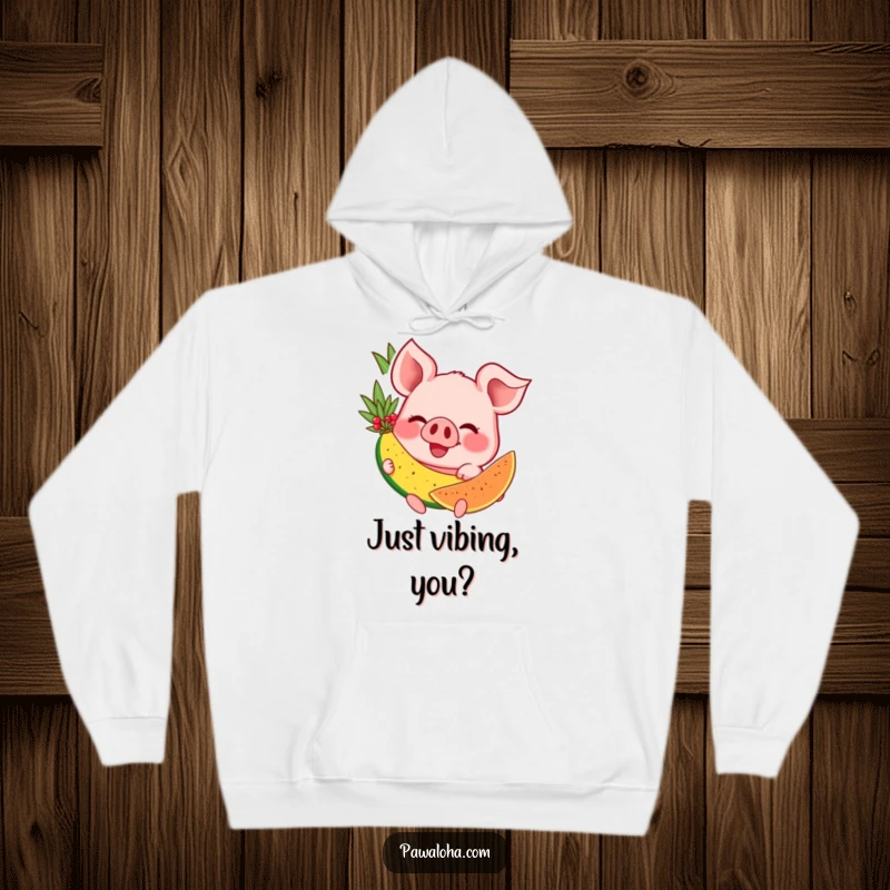 Funny hoodie showcasing a blissfully happy pig with a huge grin, savoring a delicious tropical fruit in a cozy setting.