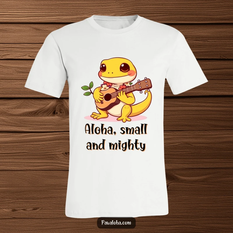 Funny t-shirt showcasing a kawaii gecko wearing a lei and enthusiastically strumming a tiny ukulele, radiating happy island vibes.