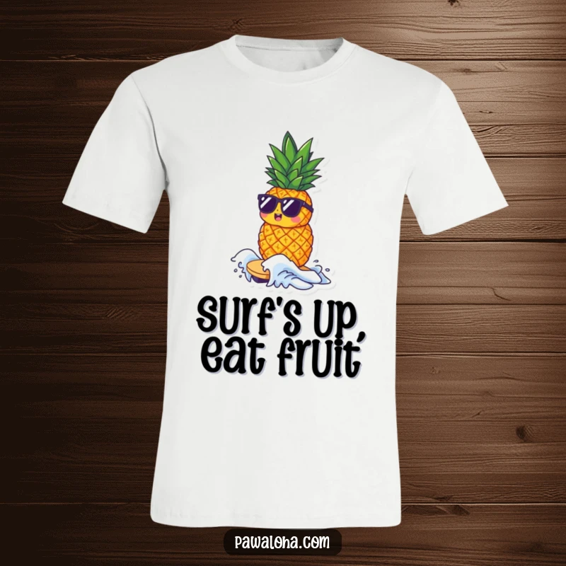 Funny t-shirt showing a small pineapple character wearing sunglasses, expertly riding a tiny wave with a cool and confident style.